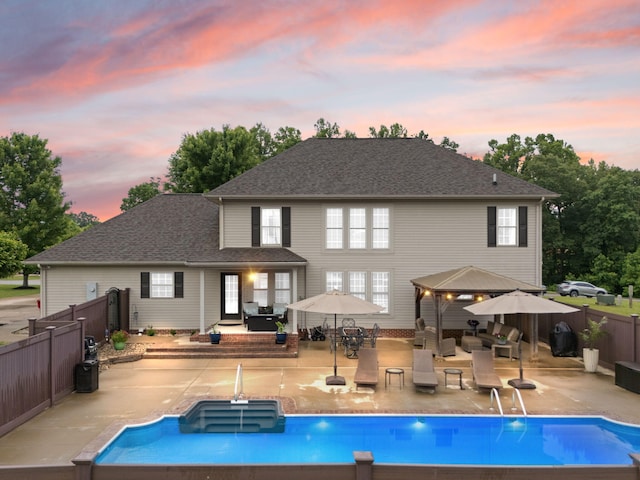 398 Arden Dr, London, KY 40741 - back of house at dusk featuring a patio, a fenced backyard, a gazebo, and an outdoor hangout area