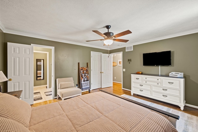 105 Wellington Cv, Danville, KY 40422 - bedroom featuring wood finished floors, crown molding, a textured ceiling, baseboards, and a ceiling fan