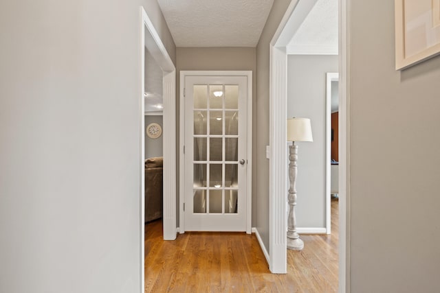 105 Wellington Cv, Danville, KY 40422 - hall featuring light wood-style floors, a textured ceiling, and baseboards