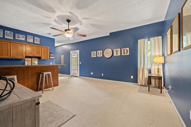 105 Wellington Cv, Danville, KY 40422 - kitchen featuring light colored carpet, ceiling fan, a textured ceiling, brown cabinets, and baseboards