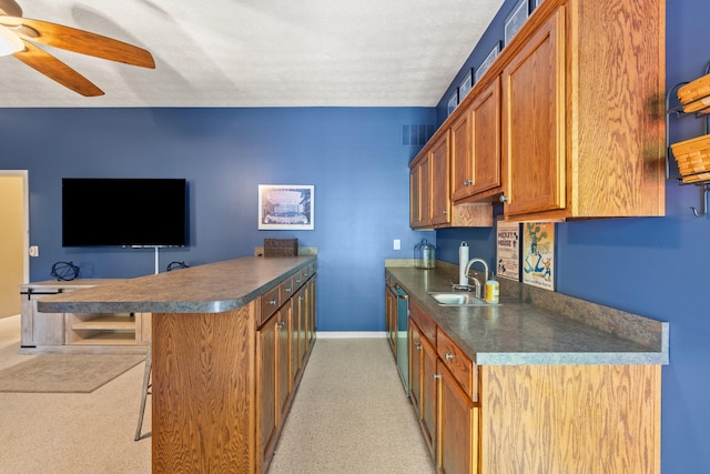 105 Wellington Cv, Danville, KY 40422 - kitchen featuring a sink, a peninsula, dark countertops, baseboards, and a textured ceiling