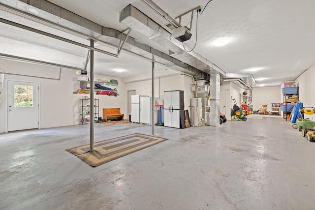 105 Wellington Cv, Danville, KY 40422 - garage with freestanding refrigerator, gas water heater, heating unit, and a garage door opener