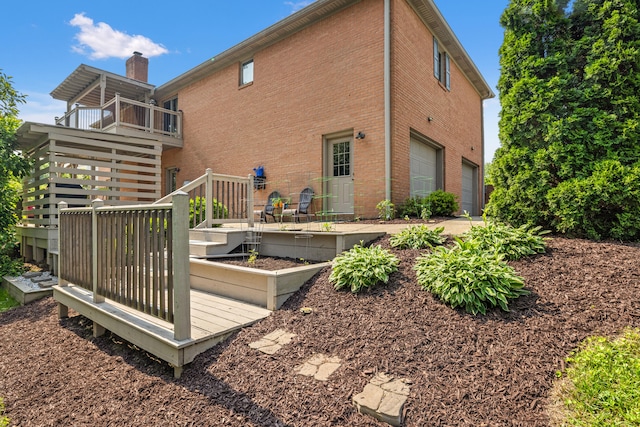 105 Wellington Cv, Danville, KY 40422 - back of house featuring brick siding, a garage, a garden, and a chimney
