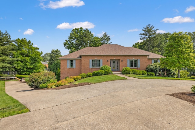 105 Wellington Cv, Danville, KY 40422 - view of front of property with a trampoline, brick siding, and a front yard