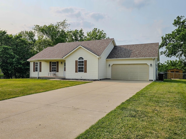 186 Amber Ln, Hustonville, KY 40437 - ranch-style home featuring a garage, concrete driveway, a front yard, a porch, and roof with shingles
