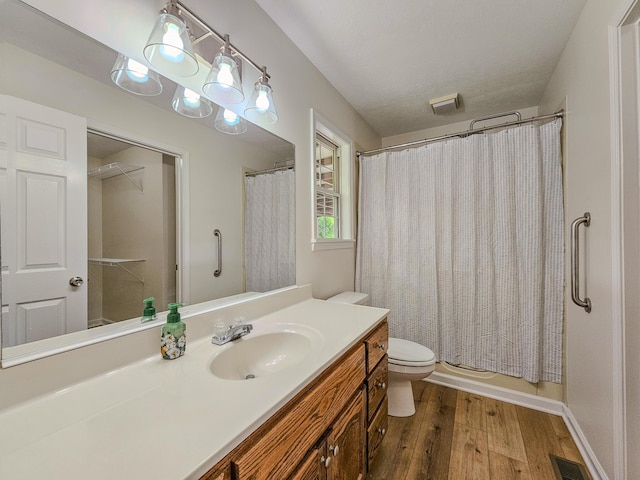 186 Amber Ln, Hustonville, KY 40437 - bathroom with toilet, vanity, wood finished floors, and shower / bath combination with curtain