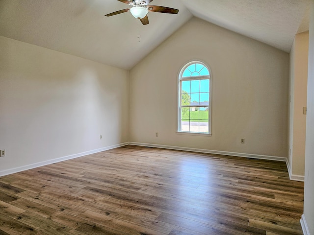 186 Amber Ln, Hustonville, KY 40437 - unfurnished room featuring ceiling fan, vaulted ceiling, wood finished floors, and baseboards