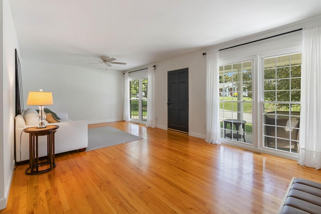 131 Reasor St, Corbin, KY 40701 - unfurnished living room featuring a ceiling fan, light wood-style flooring, and baseboards