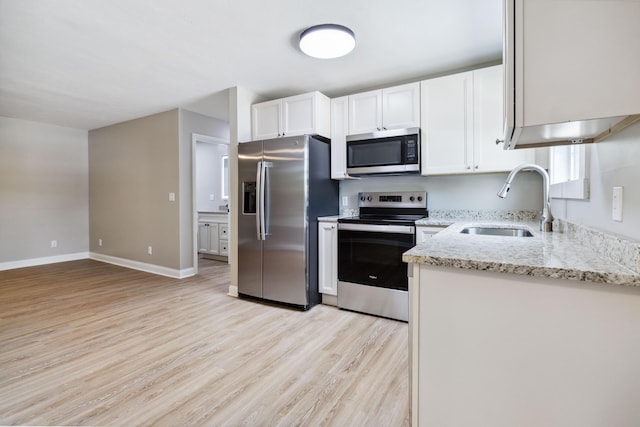 56 Hopewell Church Rd, Corbin, KY 40701 - kitchen with appliances with stainless steel finishes, a sink, light wood-style flooring, and light stone counters