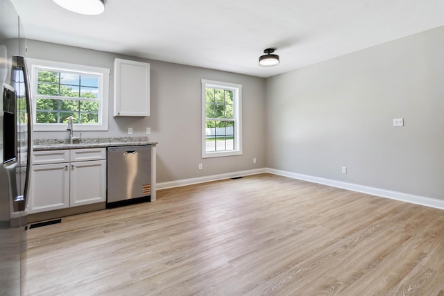 56 Hopewell Church Rd, Corbin, KY 40701 - kitchen with appliances with stainless steel finishes, light wood finished floors, plenty of natural light, and baseboards