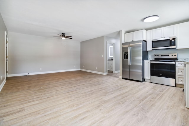 56 Hopewell Church Rd, Corbin, KY 40701 - kitchen with stainless steel appliances, ceiling fan, white cabinets, light wood-style floors, and baseboards
