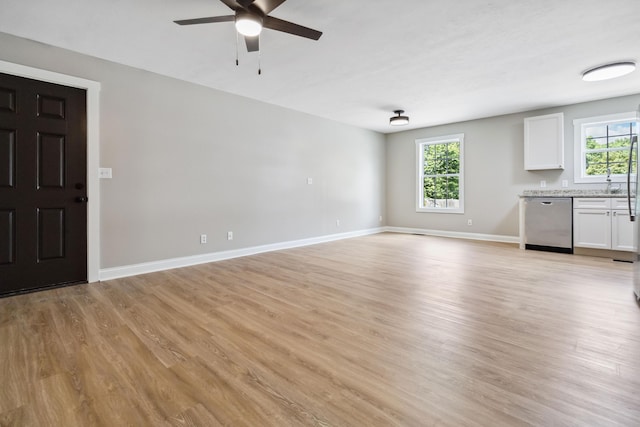 56 Hopewell Church Rd, Corbin, KY 40701 - unfurnished living room featuring a ceiling fan, light wood finished floors, and baseboards