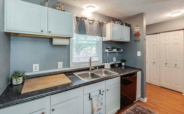 3471 Pimlico Pkwy Unit B, Lexington, KY 40517 - kitchen with a sink, black dishwasher, light wood-style flooring, a textured ceiling, and dark countertops