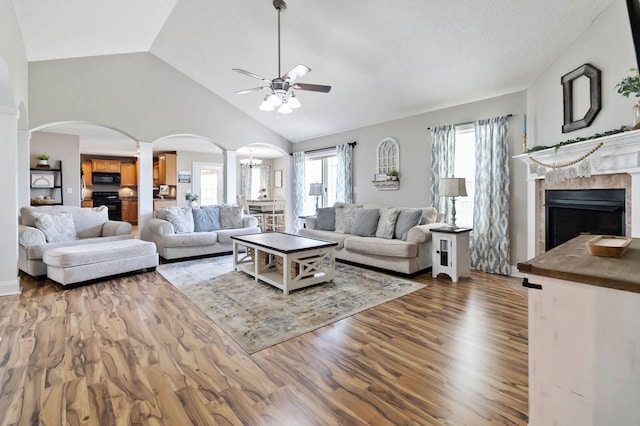 468 Whisper Woods Dr, Somerset, KY 42503 - living room with a ceiling fan, arched walkways, decorative columns, wood finished floors, and a tile fireplace