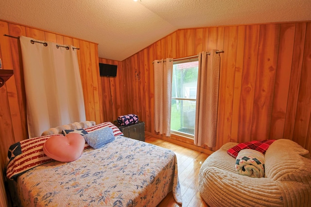 2858 Ford Hampton Rd, Winchester, KY 40391 - bedroom featuring lofted ceiling, light wood finished floors, wood walls, and a textured ceiling