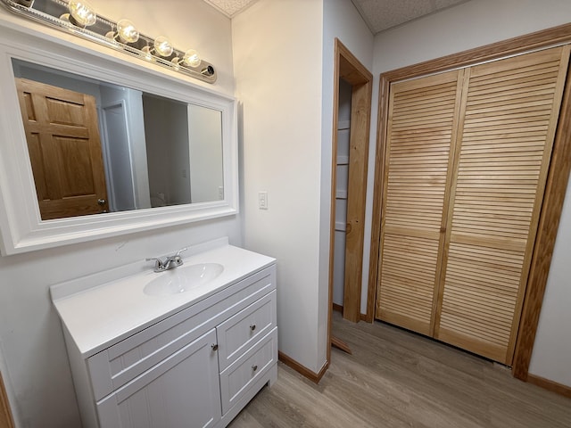 1090 Laurel Cove Rd, London, KY 40744 - bathroom featuring vanity, wood finished floors, and baseboards