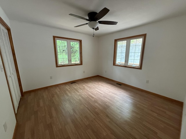 1090 Laurel Cove Rd, London, KY 40744 - unfurnished bedroom with multiple windows, wood finished floors, baseboards, and a closet
