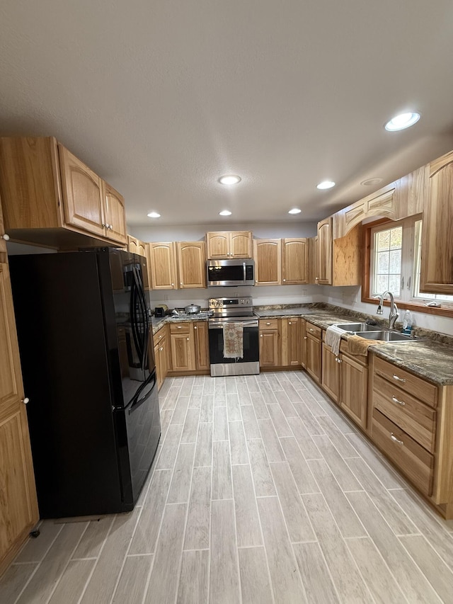 1090 Laurel Cove Rd, London, KY 40744 - kitchen with appliances with stainless steel finishes, a sink, light wood-style flooring, recessed lighting, and dark stone countertops