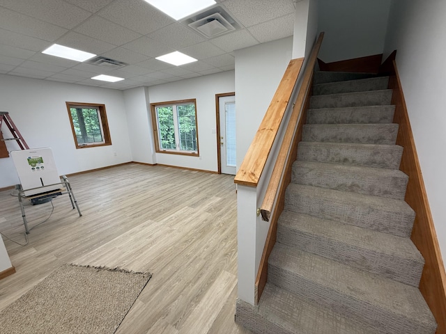 1090 Laurel Cove Rd, London, KY 40744 - stairway featuring a drop ceiling, wood finished floors, and baseboards