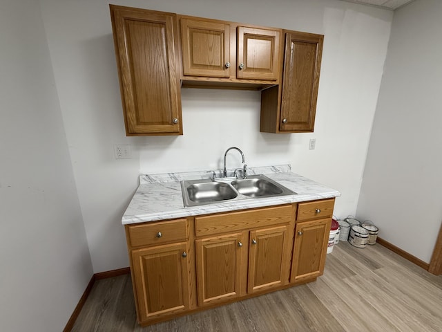 1090 Laurel Cove Rd, London, KY 40744 - kitchen featuring a sink, light wood-style floors, light countertops, and baseboards