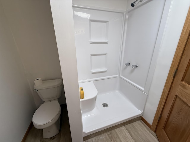 1090 Laurel Cove Rd, London, KY 40744 - full bathroom featuring a stall shower, wood finished floors, toilet, and baseboards
