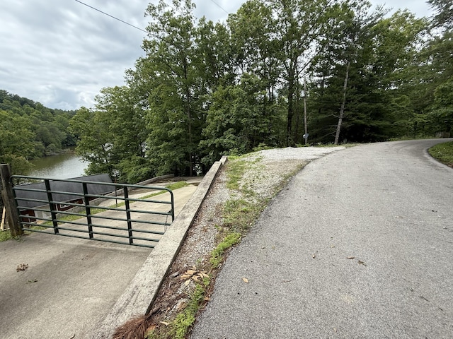 1090 Laurel Cove Rd, London, KY 40744 - view of asphalt road with a gate, a view of trees, and a water view