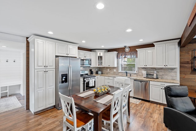 795 Allendale Dr, Lexington, KY 40503 - kitchen with appliances with stainless steel finishes, light wood finished floors, backsplash, white cabinets, and light stone counters
