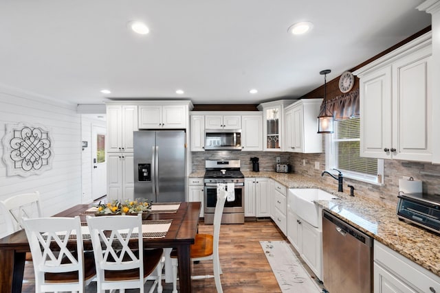 795 Allendale Dr, Lexington, KY 40503 - kitchen with appliances with stainless steel finishes, a sink, wood finished floors, backsplash, and white cabinetry