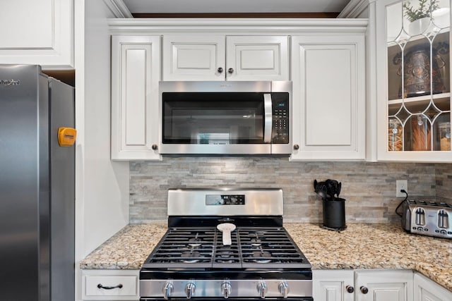 795 Allendale Dr, Lexington, KY 40503 - kitchen with appliances with stainless steel finishes, white cabinets, backsplash, light stone countertops, and ornamental molding