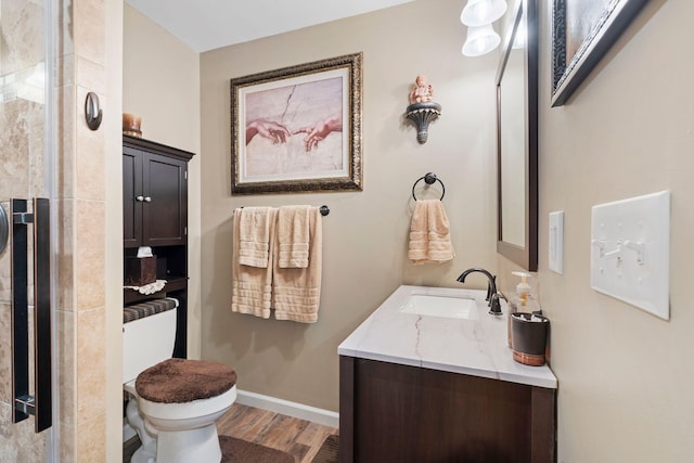 795 Allendale Dr, Lexington, KY 40503 - bathroom with wood finished floors, toilet, vanity, a tile shower, and baseboards