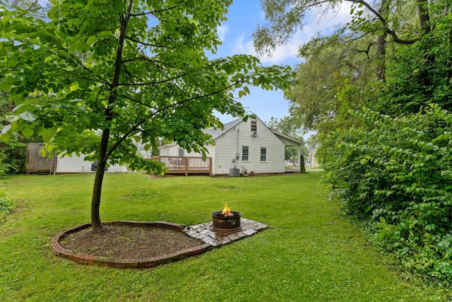 795 Allendale Dr, Lexington, KY 40503 - view of grassy yard with an outdoor fire pit, a deck, and central AC unit