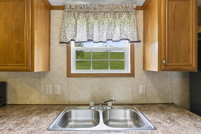 6125 Cincinnati Pike, Sadieville, KY 40370 - kitchen featuring a sink, brown cabinetry, and tasteful backsplash