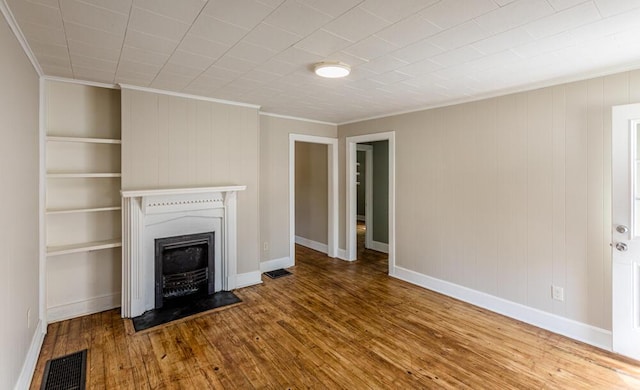 100 Mcdonald St, Nicholasville, KY 40356 - unfurnished living room featuring crown molding, wood finished floors, a fireplace, baseboards, and wooden walls