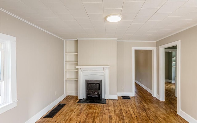100 Mcdonald St, Nicholasville, KY 40356 - unfurnished living room with ornamental molding, wood finished floors, a fireplace with flush hearth, and baseboards