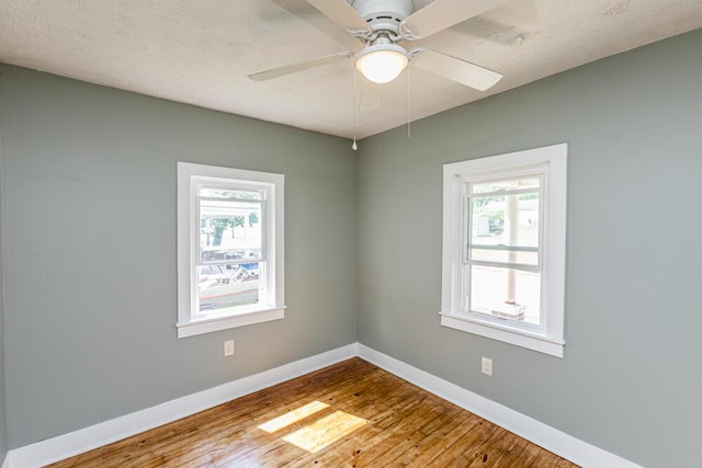 100 Mcdonald St, Nicholasville, KY 40356 - spare room with healthy amount of natural light, wood finished floors, baseboards, and a ceiling fan