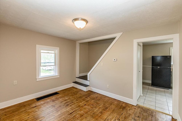 100 Mcdonald St, Nicholasville, KY 40356 - unfurnished room with wood finished floors, baseboards, and stairway