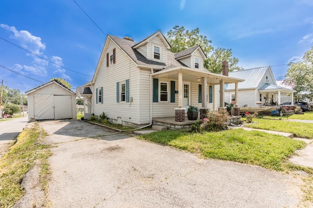 100 Mcdonald St, Nicholasville, KY 40356 - view of front of home with driveway, covered porch, an outdoor structure, and a detached garage