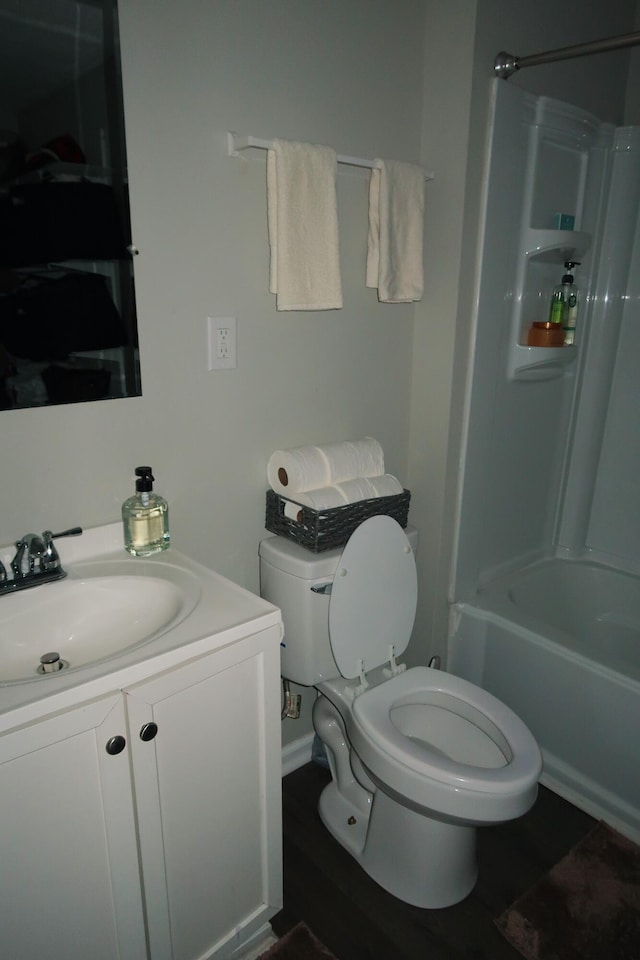 557 Chestnut St, Lexington, KY 40508 - bathroom with toilet, vanity, bathtub / shower combination, and wood finished floors