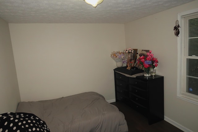 557 Chestnut St, Lexington, KY 40508 - bedroom featuring a textured ceiling, baseboards, and dark wood-type flooring