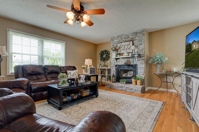 220 Mcdowell Dr, Winchester, KY 40391 - living room with a fireplace, ceiling fan, wood finished floors, and a textured ceiling