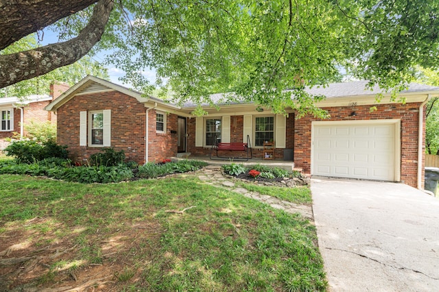 1128 Kiowa Trl, Frankfort, KY 40601 - ranch-style house with brick siding, covered porch, an attached garage, and driveway