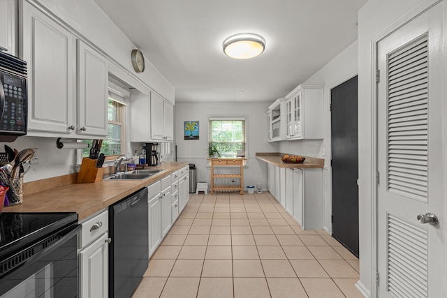 1128 Kiowa Trl, Frankfort, KY 40601 - kitchen with black appliances, white cabinets, glass insert cabinets, light tile patterned floors, and light countertops