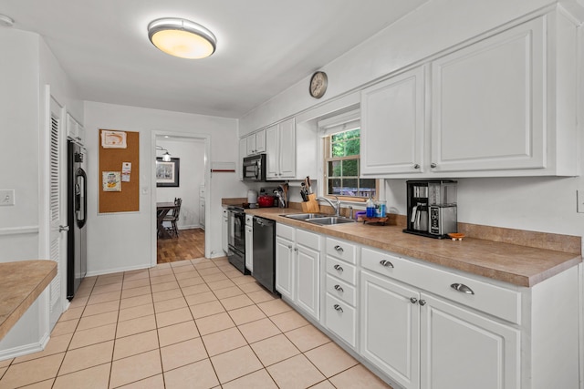1128 Kiowa Trl, Frankfort, KY 40601 - kitchen with black appliances, white cabinetry, light tile patterned flooring, and light countertops