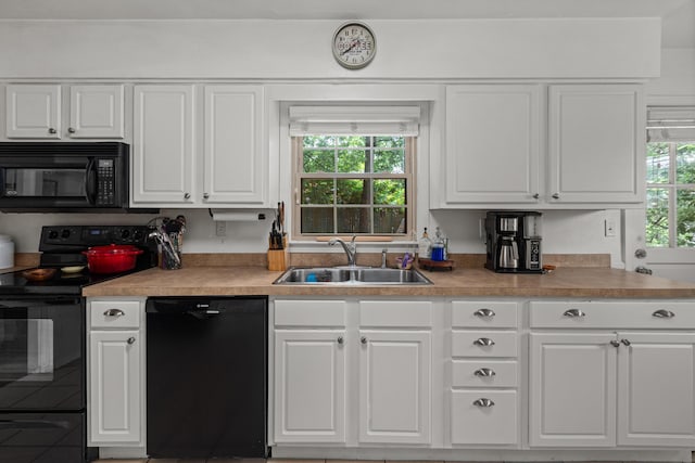 1128 Kiowa Trl, Frankfort, KY 40601 - kitchen with black appliances, plenty of natural light, and white cabinets