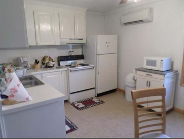 130 Morgan View Rd, Wellington, KY 40387 - kitchen with white appliances, a wall mounted AC, under cabinet range hood, and white cabinetry