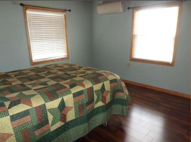 130 Morgan View Rd, Wellington, KY 40387 - bedroom with wood finished floors, a wall mounted air conditioner, and baseboards
