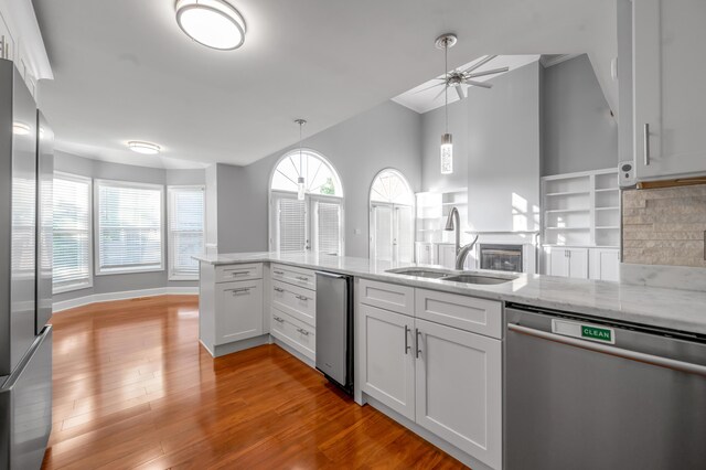 244 Chippendale Cir, Lexington, KY 40517 - kitchen featuring appliances with stainless steel finishes, a sink, a ceiling fan, light wood-type flooring, and light stone countertops