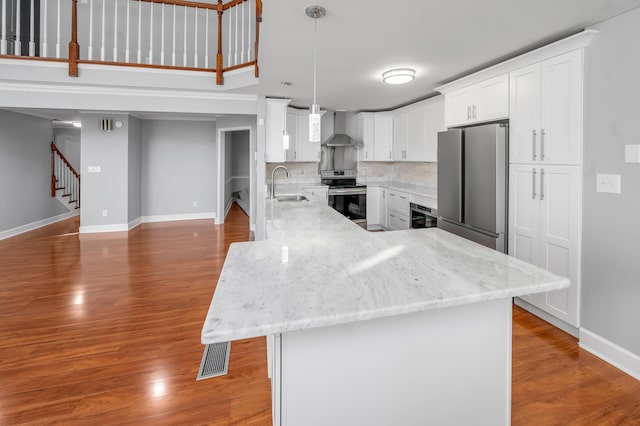 244 Chippendale Cir, Lexington, KY 40517 - kitchen featuring appliances with stainless steel finishes, wall chimney range hood, a sink, baseboards, and wood finished floors