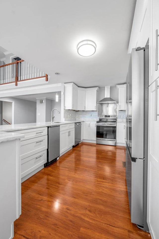 244 Chippendale Cir, Lexington, KY 40517 - kitchen featuring appliances with stainless steel finishes, wall chimney exhaust hood, light countertops, and white cabinetry