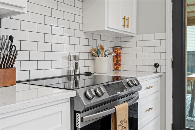 588 E Fifth St, Lexington, KY 40508 - kitchen featuring stainless steel electric range, decorative backsplash, white cabinetry, and light stone countertops
